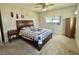 Bedroom featuring a cozy bed with a blue and white quilt and a vintage ceiling fan at 424 Hawthorne Blvd, Leesburg, FL 34748