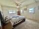 Bedroom featuring a cozy bed with a blue and white quilt and a vintage ceiling fan at 424 Hawthorne Blvd, Leesburg, FL 34748