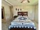 Bedroom featuring a cozy bed with a blue and white quilt and a vintage ceiling fan at 424 Hawthorne Blvd, Leesburg, FL 34748