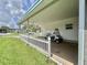 A well-kept carport featuring a golf cart and an adjacent small, fenced yard at 424 Hawthorne Blvd, Leesburg, FL 34748