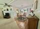 Charming dining area adjacent to the living space, featuring a lovely table set and hardwood floors at 424 Hawthorne Blvd, Leesburg, FL 34748