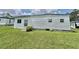 This home features vinyl siding, brick skirting, a storm door and well-kept landscaping at 424 Hawthorne Blvd, Leesburg, FL 34748