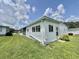 This home has vinyl siding, brick skirting, well-kept landscaping and an enclosed lanai at 424 Hawthorne Blvd, Leesburg, FL 34748
