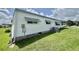 This home features vinyl siding, brick skirting, awning windows and air conditioning unit at 424 Hawthorne Blvd, Leesburg, FL 34748