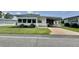 Charming single-story home with well-maintained lawn, white picket fence, and covered carport at 424 Hawthorne Blvd, Leesburg, FL 34748