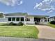 Charming single-story home with a well-kept lawn, picket fence, and covered parking at 424 Hawthorne Blvd, Leesburg, FL 34748