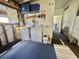 Functional laundry area with machines, sink, storage shelves, and blue carpeting at 424 Hawthorne Blvd, Leesburg, FL 34748