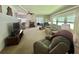 Spacious living room with large windows, comfortable seating, and views into the dining area at 424 Hawthorne Blvd, Leesburg, FL 34748