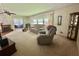 Relaxing living room showcasing a fireplace, comfortable furniture, and seamless access to the outdoors at 424 Hawthorne Blvd, Leesburg, FL 34748