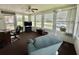 Bright sunroom with multiple windows offering neighborhood views and comfortable seating at 424 Hawthorne Blvd, Leesburg, FL 34748