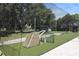 Outdoor baseball cage with netting, pitching machine, and lush green turf for practice at 5008 Sawgrass Lake Cir, Leesburg, FL 34748