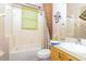 Bathroom featuring a vanity, toilet, and shower-tub combo at 5008 Sawgrass Lake Cir, Leesburg, FL 34748