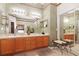 Bathroom with double sinks, vanity, lighting, and mirrors at 5008 Sawgrass Lake Cir, Leesburg, FL 34748