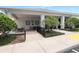 View of the clubhouse exterior with covered seating area and manicured bushes at 5008 Sawgrass Lake Cir, Leesburg, FL 34748
