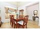 Bright dining room features a wooden dining table, chandelier, and scenic window view at 5008 Sawgrass Lake Cir, Leesburg, FL 34748
