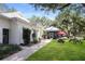 Charming exterior of white brick building with green shutters and picnic area with picnic tables at 5008 Sawgrass Lake Cir, Leesburg, FL 34748