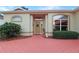Inviting front entrance with brick pathway, meticulously maintained landscaping, and decorative accents at 5008 Sawgrass Lake Cir, Leesburg, FL 34748