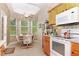 Bright breakfast nook with tiled floors, breakfast table and chairs, and a view of outdoors at 5008 Sawgrass Lake Cir, Leesburg, FL 34748