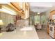 Well-lit kitchen featuring a light countertop and an adjacent breakfast nook with natural light at 5008 Sawgrass Lake Cir, Leesburg, FL 34748