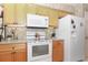 Functional kitchen with white appliances, ample counter space, and warm-toned cabinetry at 5008 Sawgrass Lake Cir, Leesburg, FL 34748