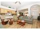 Cozy living room features comfortable seating, wood flooring, and seamless flow to other living spaces at 5008 Sawgrass Lake Cir, Leesburg, FL 34748