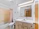 Bathroom features a vanity, mirror, and shower-tub combo at 512 Galloway Ct, Leesburg, FL 34788
