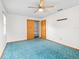 Spacious bedroom features neutral walls, a ceiling fan, and closet at 512 Galloway Ct, Leesburg, FL 34788