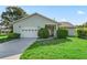 Charming single-story home with a well-manicured lawn and attached one car garage at 512 Galloway Ct, Leesburg, FL 34788