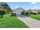Charming single-story home with a well-manicured lawn and attached one car garage at 512 Galloway Ct, Leesburg, FL 34788