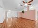 Spacious living room features hardwood floors, a ceiling fan, and ample natural light at 512 Galloway Ct, Leesburg, FL 34788