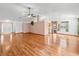 Open-concept living room with hardwood floors and large windows providing ample light at 512 Galloway Ct, Leesburg, FL 34788