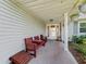 Inviting covered porch with seating, offering a relaxing outdoor space at 512 Galloway Ct, Leesburg, FL 34788