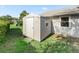 A storage shed sits on the lawn next to the house, providing convenient outdoor storage at 512 Galloway Ct, Leesburg, FL 34788