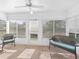 Bright sunroom with lots of windows and wicker furniture at 512 Galloway Ct, Leesburg, FL 34788