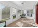 Bright sunroom with lots of windows and wicker furniture at 512 Galloway Ct, Leesburg, FL 34788