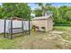Backyard features include a new shed, hanging bench, grill, and secure fencing for added privacy at 520 Dora Ave, Tavares, FL 32778