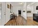 Inviting dining room with natural light, modern hardwood floors, and open access to other living spaces at 520 Dora Ave, Tavares, FL 32778