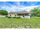 Charming single-story home with a screened porch and a well-maintained front yard at 520 Dora Ave, Tavares, FL 32778