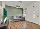 Cozy living room featuring a comfortable sofa, hardwood floors, and neutral wall color at 520 Dora Ave, Tavares, FL 32778
