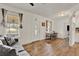 Bright living room with wood-look flooring, white walls, and ample natural light at 520 Dora Ave, Tavares, FL 32778
