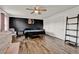 Spacious bedroom with a dark accent wall, ceiling fan, and wood-look flooring at 520 Dora Ave, Tavares, FL 32778