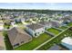 Aerial view of a neighborhood showcases backyard with green lawn and privacy fence at 5386 Pine Lilly Dr, St Cloud, FL 34771