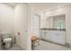 Well-lit full bathroom including a tiled floor, vanity, toilet, and decoratively adorned toilet paper holder at 5386 Pine Lilly Dr, St Cloud, FL 34771
