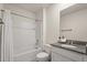 White bathroom including a bathtub, shower, and a marble countertop vanity at 5386 Pine Lilly Dr, St Cloud, FL 34771