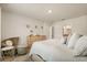 Spacious bedroom with carpet, including a dresser and chair and a decorative wall at 5386 Pine Lilly Dr, St Cloud, FL 34771