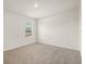 Carpeted room featuring natural light through the window at 5386 Pine Lilly Dr, St Cloud, FL 34771