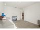 Well-lit bedroom featuring neutral carpet, gray furniture, and white walls, with a connected bathroom area at 5386 Pine Lilly Dr, St Cloud, FL 34771