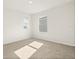 Cozy bedroom with carpet, two windows providing natural light, and clean, white walls. Minimalistic design at 5386 Pine Lilly Dr, St Cloud, FL 34771