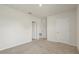 Spacious bedroom with neutral walls, carpet flooring, and multiple doors at 5386 Pine Lilly Dr, St Cloud, FL 34771