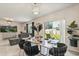 Elegant dining area with modern table setting, stylish chairs, and backyard view at 5386 Pine Lilly Dr, St Cloud, FL 34771